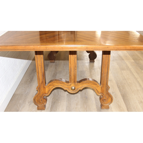 86 - An early 20th century walnut extending dining table with decorative Spanish Baroque style base, with... 
