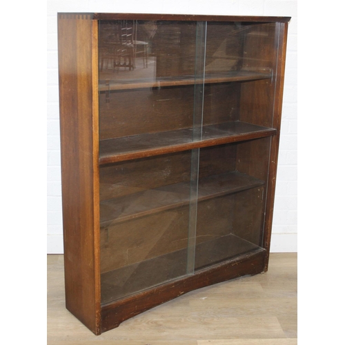93 - Mid-20th century oak bookcase with two sets of glass sliding doors, 91cm x 25cm x 113cm