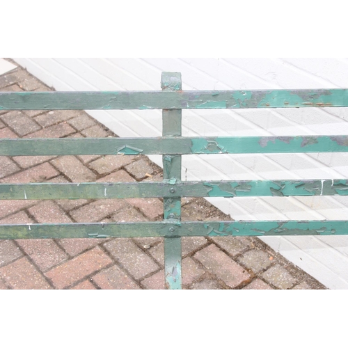 324 - Antique green painted wrought iron garden bench with scroll end detail, late 19th or early 20th cent... 