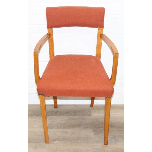 25 - A pair of retro armchairs with terracotta coloured upholstery, approx 81cm tall