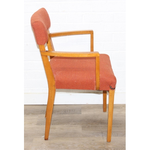 25 - A pair of retro armchairs with terracotta coloured upholstery, approx 81cm tall
