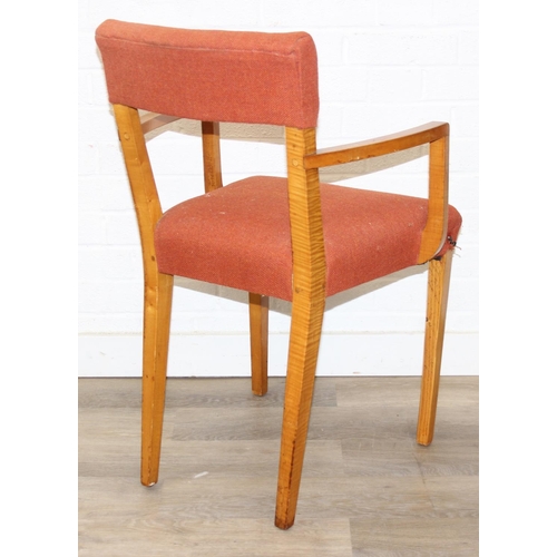 25 - A pair of retro armchairs with terracotta coloured upholstery, approx 81cm tall