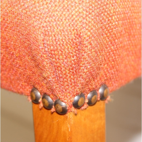 25 - A pair of retro armchairs with terracotta coloured upholstery, approx 81cm tall