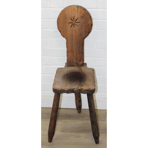 46 - An unusual vintage pitch pine spinning chair with carved decoration, three legs, 87cm tall