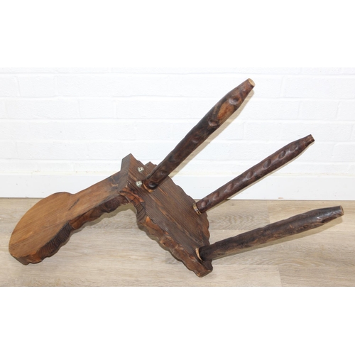 46 - An unusual vintage pitch pine spinning chair with carved decoration, three legs, 87cm tall