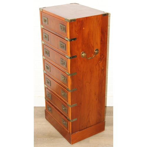 19 - A modern yew wood effect campaign chest with seven drawers and recessed brass campaign style handles... 