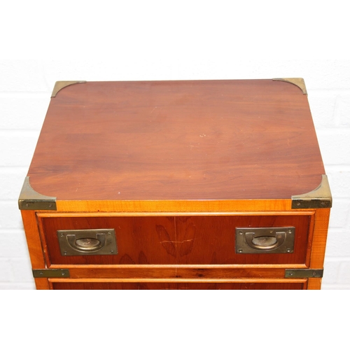 19 - A modern yew wood effect campaign chest with seven drawers and recessed brass campaign style handles... 