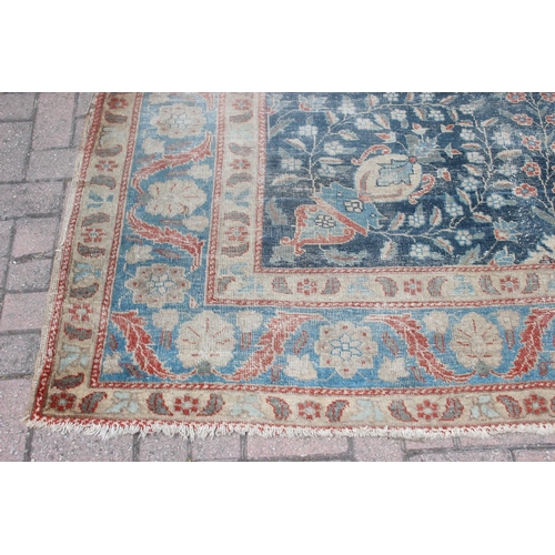 224 - A large vintage Persian rug, believed to be a Tabriz, blue ground with red border, 380cm x 274cm