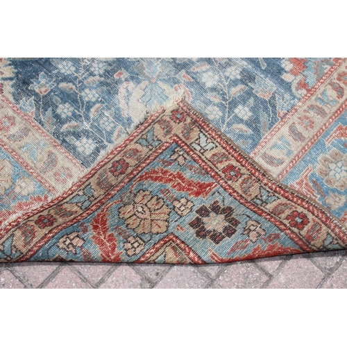 224 - A large vintage Persian rug, believed to be a Tabriz, blue ground with red border, 380cm x 274cm