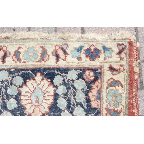 225 - A large vintage Perisan rug, believed to be a Tabriz, blue ground with dark blue border, 380cm x 274... 