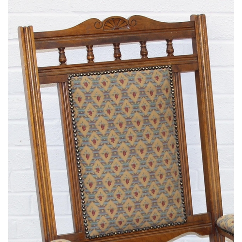 187 - An early 20th century rocking chair with decorative floral upholstery, possibly American, 107cm tall
