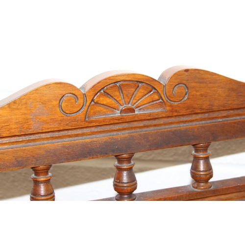 187 - An early 20th century rocking chair with decorative floral upholstery, possibly American, 107cm tall