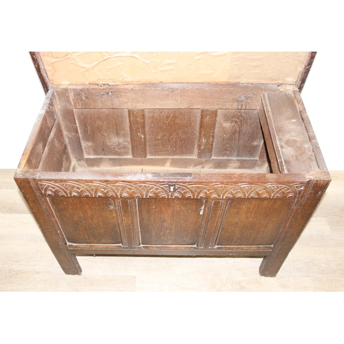 195 - An antique oak coffer with carved details and candle box to interior, likely 18th century, unusual s... 