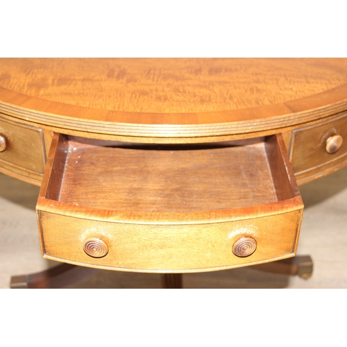 78 - An antique style drum or library table with inlay, four real drawers and four faux drawers, 91cm in ... 