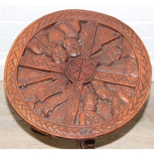 66 - Three African carved hardwood folding tables, the tops carved with elephants, rhinos, giraffes etc, ... 