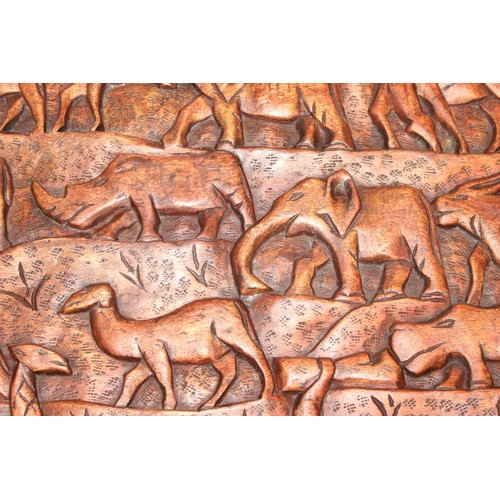 66 - Three African carved hardwood folding tables, the tops carved with elephants, rhinos, giraffes etc, ... 