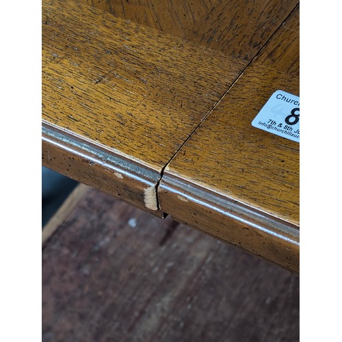 86 - An early 20th century walnut extending dining table with decorative Spanish Baroque style base, with... 