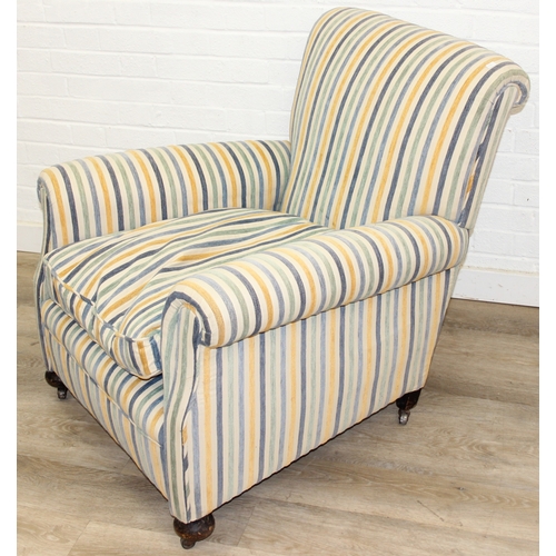 75 - In the manner of Howard & Sons, an antique deep seated armchair with multi-coloured stripey upholste... 