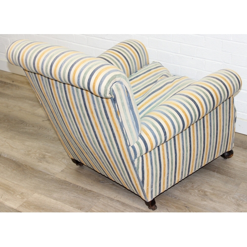 75 - In the manner of Howard & Sons, an antique deep seated armchair with multi-coloured stripey upholste... 