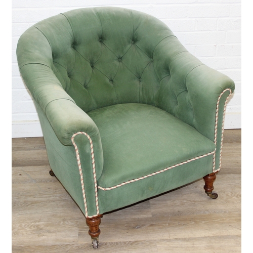 97 - An antique green upholstered tub chair with button backed upholstery, turned wooden legs and brass a... 