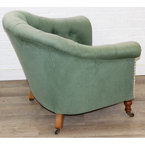 97 - An antique green upholstered tub chair with button backed upholstery, turned wooden legs and brass a... 