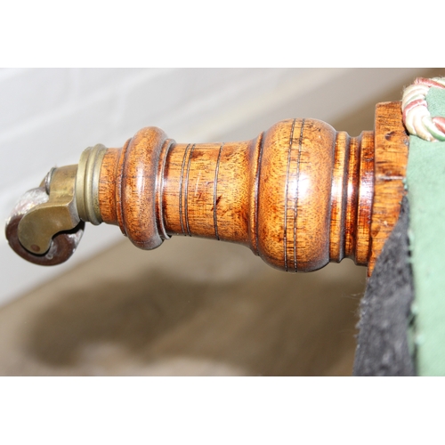 97 - An antique green upholstered tub chair with button backed upholstery, turned wooden legs and brass a... 