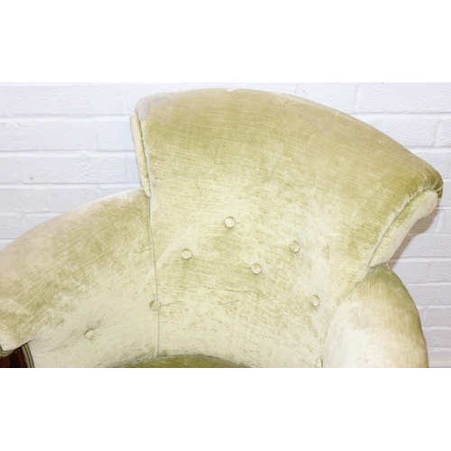 68 - A Victorian tub chair or armchair with green buttoned velvet upholstery and exposed carved wooden fr... 