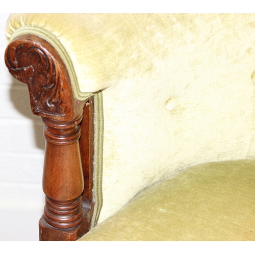 68 - A Victorian tub chair or armchair with green buttoned velvet upholstery and exposed carved wooden fr... 