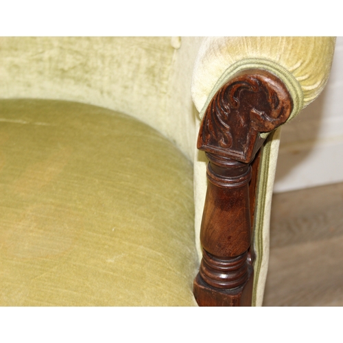 68 - A Victorian tub chair or armchair with green buttoned velvet upholstery and exposed carved wooden fr... 