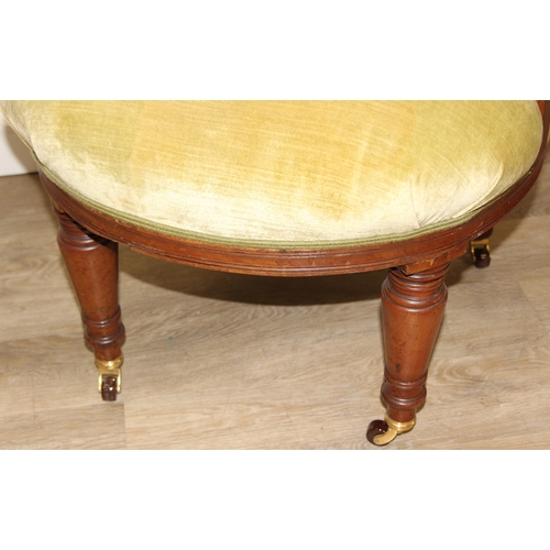 68 - A Victorian tub chair or armchair with green buttoned velvet upholstery and exposed carved wooden fr... 