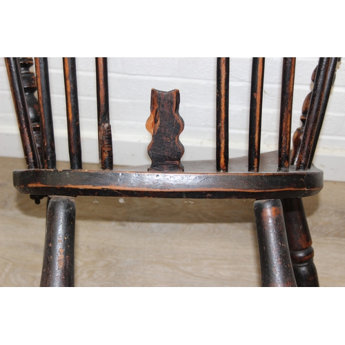 107 - An antique farmhouse stick-back Windsor armchair with elm seat, 19th century, with some very rustic ... 