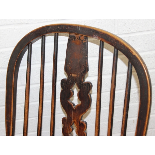 107 - An antique farmhouse stick-back Windsor armchair with elm seat, 19th century, with some very rustic ... 