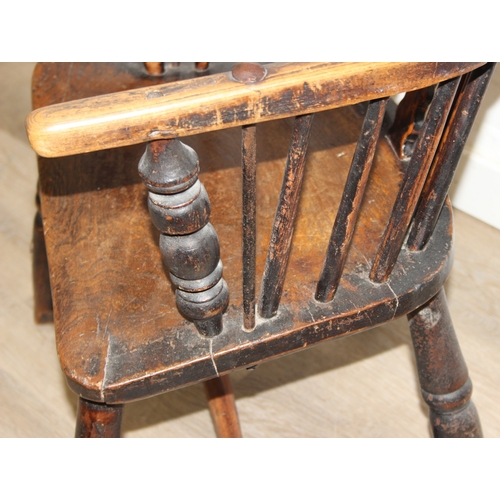 107 - An antique farmhouse stick-back Windsor armchair with elm seat, 19th century, with some very rustic ... 