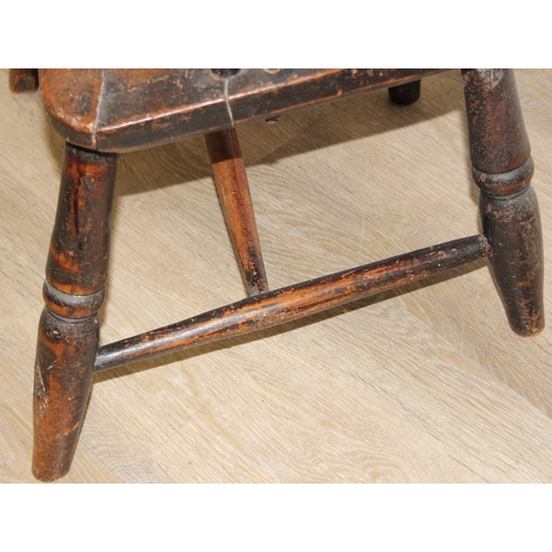 107 - An antique farmhouse stick-back Windsor armchair with elm seat, 19th century, with some very rustic ... 