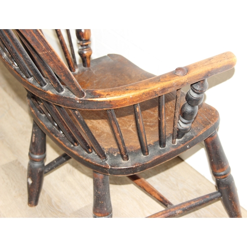 107 - An antique farmhouse stick-back Windsor armchair with elm seat, 19th century, with some very rustic ... 