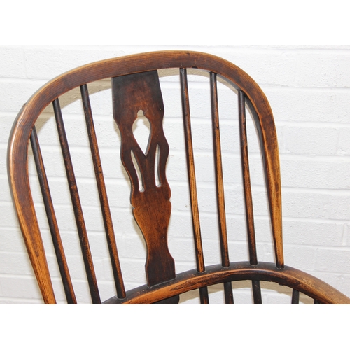108 - An antique farmhouse stick-back Windsor armchair with elm seat, 19th century, 56cm wide x 113cm tall