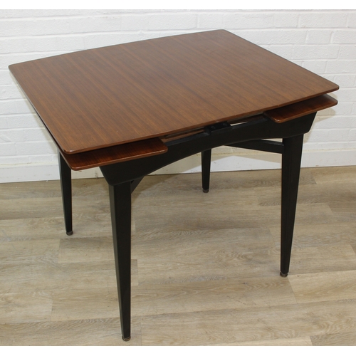 99 - A retro 1950's extending dining table and four chairs, the chairs with red fabric upholstery, seemin... 
