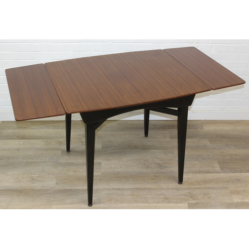 99 - A retro 1950's extending dining table and four chairs, the chairs with red fabric upholstery, seemin... 