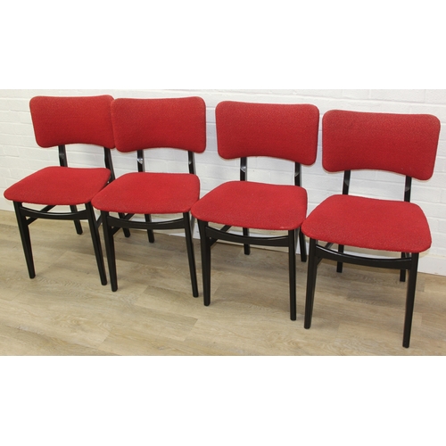 99 - A retro 1950's extending dining table and four chairs, the chairs with red fabric upholstery, seemin... 