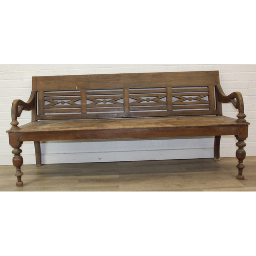 73 - A large hallway or conservatory garden bench with cut our back, scroll arms and turned legs, 20th ce... 