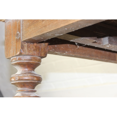 73 - A large hallway or conservatory garden bench with cut our back, scroll arms and turned legs, 20th ce... 