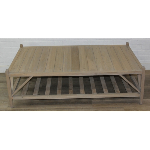 113 - A modern limed light oak coffee table with slatted undertier, no makers mark but a hand stamped bras... 