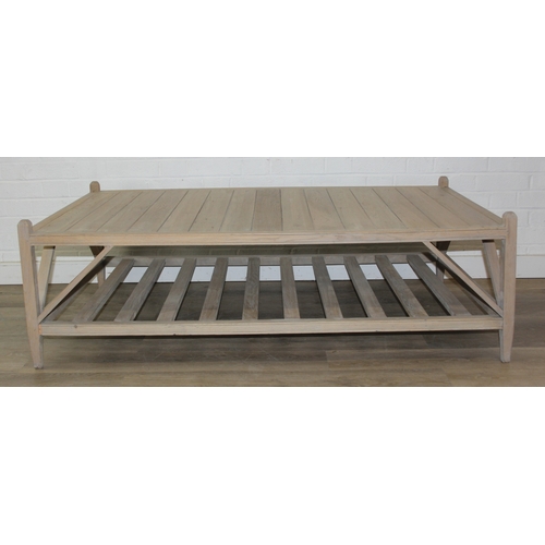 113 - A modern limed light oak coffee table with slatted undertier, no makers mark but a hand stamped bras... 
