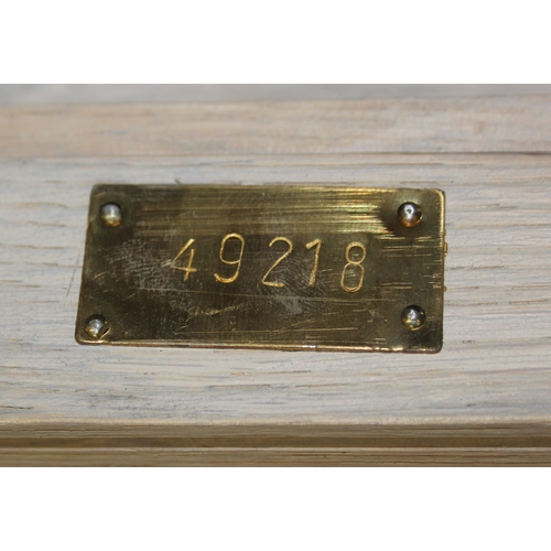 113 - A modern limed light oak coffee table with slatted undertier, no makers mark but a hand stamped bras... 