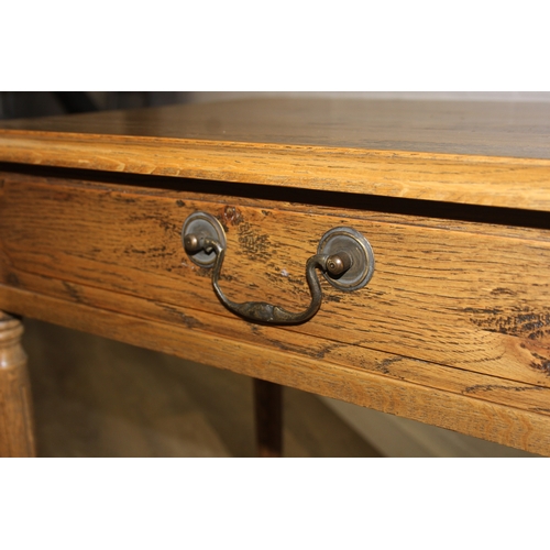 74 - A distressed oak bedside table with single drawer and brass handle, 65cm x 45cm x 75cm, one of two i... 