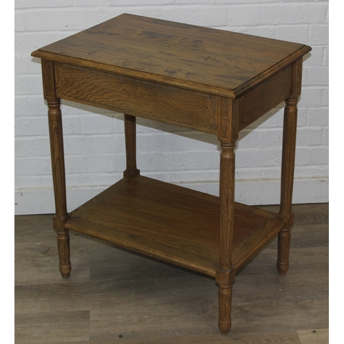 74 - A distressed oak bedside table with single drawer and brass handle, 65cm x 45cm x 75cm, one of two i... 