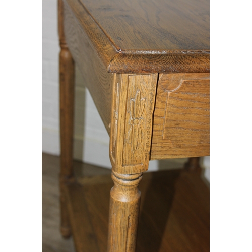 74 - A distressed oak bedside table with single drawer and brass handle, 65cm x 45cm x 75cm, one of two i... 