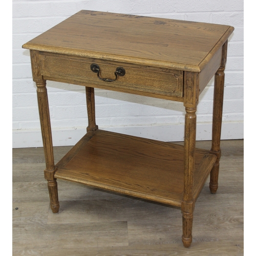 74A - A distressed oak bedside table with single drawer and brass handle, 65cm x 45cm x 75cm, one of two i... 