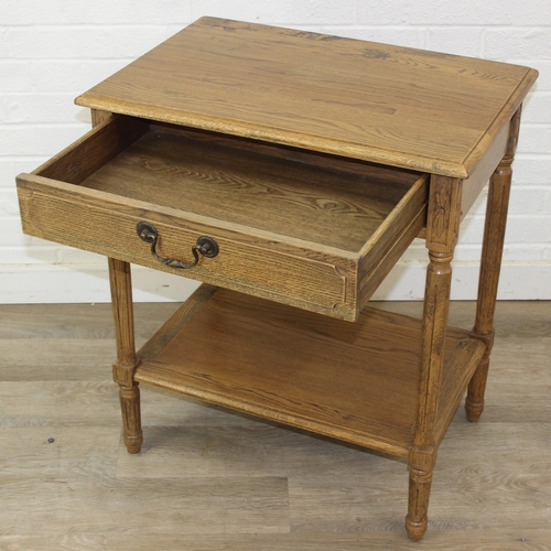 74A - A distressed oak bedside table with single drawer and brass handle, 65cm x 45cm x 75cm, one of two i... 