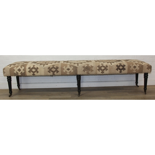 93 - A very large antique style footstool with kilim style top and turned ebonised legs, 220cm x 45cm x 5... 